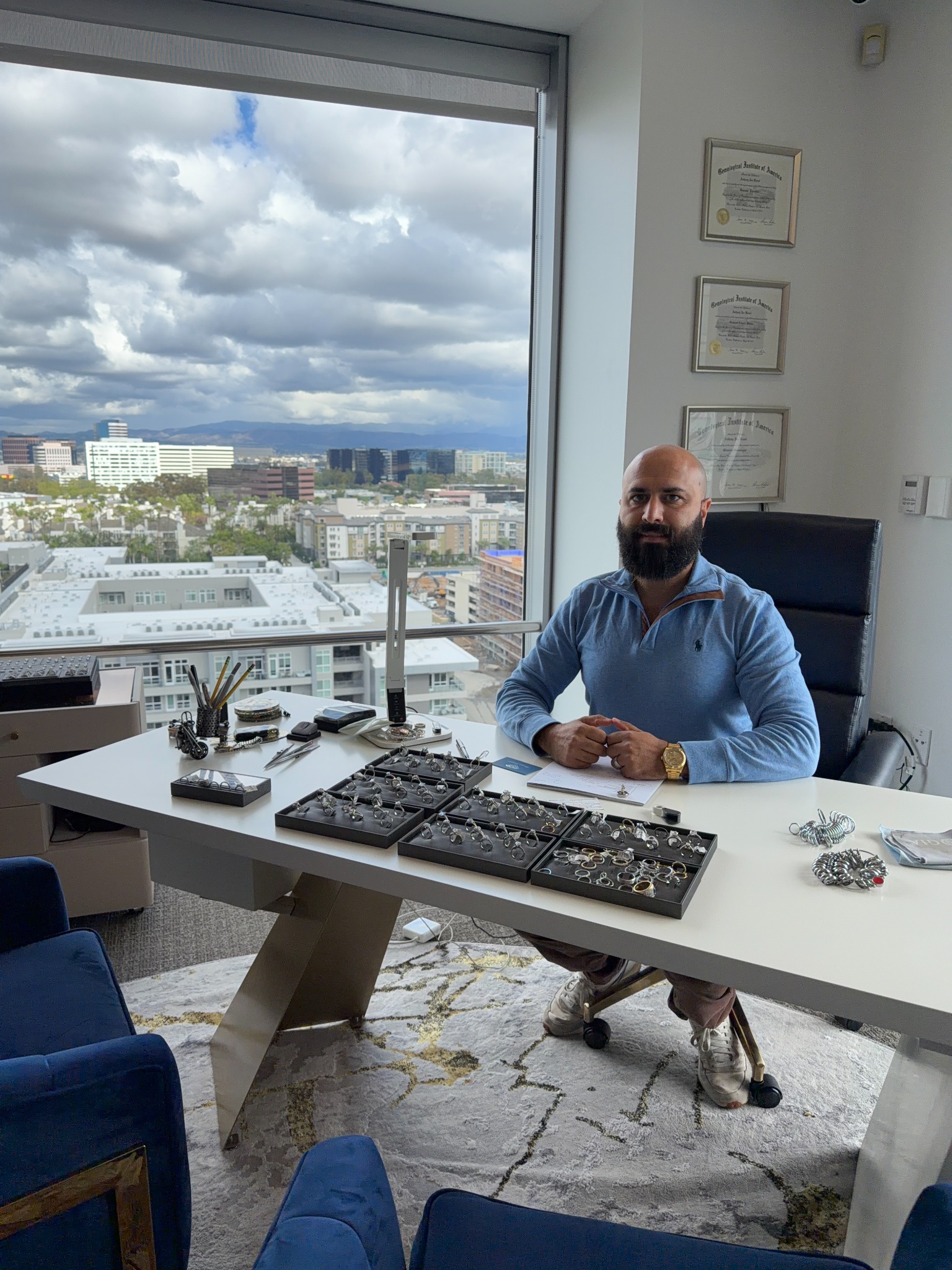 Anthony Kamel seated at a jewelry consultation desk
